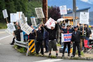 Members of the Inland Boatmens Union of the Pacific picket in front of the Auke Bay Terminal in Juneau, Alaska, Thursday, July 25, 2019. The union called a strike on Wednesday over failed negotiations with Gov. Mike Dunleavys administration. State officials said Thursday more than $580,000 in fares has been refunded to passengers affected by striking ferry workers. (Michael Penn/The Juneau Empire via AP)