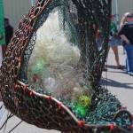 Sally, a salmon statue in front of the Kenai Watershed tent, serves as a reminder to passersby about the importance of keeping the oceans clean of fishing line on Friday, Aug. 2, 2019 at Salmonfest in Ninilchik, Alaska. (Photo by Megan Pacer/Homer News)