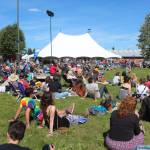 Spectators relax while listening to a musician at the Ocean Stage at this years Salmonfest on Friday, Aug. 2, 2019 in Ninilchik, Alaska. (Photo by Megan Pacer/Homer News)