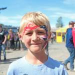 Iver Ledahl, 8, of Kenai, shows off the finished product of his face paint on Friday, Aug. 2, 2019 at Salmonfest in Ninilchik, Alaska. (Photo by Megan Pacer/Homer News)