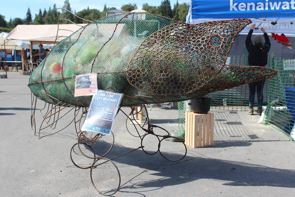 Sally, a salmon statue in front of the Kenai Watershed tent, serves as a reminder to passersby about the importance of keeping the oceans clean of fishing line on Friday, Aug. 2, 2019 at Salmonfest in Ninilchik, Alaska. (Photo by Megan Pacer/Homer News)