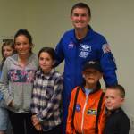 Astronaut Rex Walheim takes a photo with Sadie Doss, Ruby Doss, Silas Doss and Eli Doss at the Challenger Learning Center in Kenai, Alaska on Aug. 1, 2019. (Photo by Brian Mazurek/Peninsula Clarion)