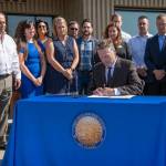 Gov. Mike Dunleavy signs SB 2002 at the Alaska Association of General Contractors in Anchorage on Thursday, Aug. 8, 2019. (Courtesy photo)