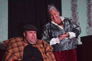 Ian McEwan (left) acts out a scene with Yvette Tappana during a rehearsel for Blazing Guns at Roaring Gulch held Thursday, Aug. 8, 2019, at the Kenai Performers stage in Soldotna. (Photo by Joey Klecka/Peninsula Clarion)