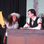 Tracie Stang (left) acts out a scene with Andrew Gunther during a rehearsel for Blazing Guns at Roaring Gulch held Thursday, Aug. 8, 2019, at the Kenai Performers stage in Soldotna. (Photo by Joey Klecka/Peninsula Clarion)