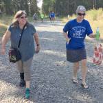 Geri Ransom and Kristin Mitchell cross the finish line at the Brewery to Bathroom .5K The race for the rest of us on Sunday, Aug. 11, 2019, in Soldotna, Alaska. (Photo by Jeff Helminiak/Peninsula Clarion)