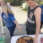 With a quarter of the race gone, Kenais David Sorensen refuels at a Kenai Watershed Forum aid station during the Brewery to Bathroom .5K The race for the rest of us on Sunday, Aug. 11, 2019, in Soldotna, Alaska. (Photo by Jeff Helminiak/Peninsula Clarion)