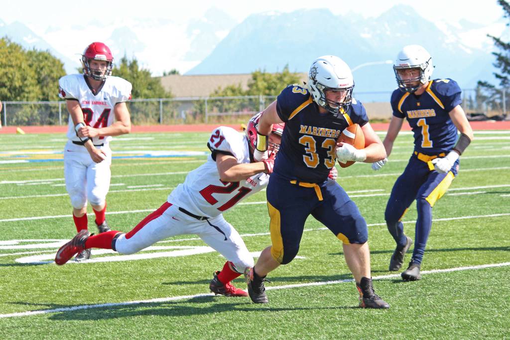 Kenai Central High Schools Zach Burnett tackles Homer High Schools Kamden Doughty during their first regular football game of the season Saturday, Aug. 17, 2019 in Homer, Alaska. (Photo by Megan Pacer/Homer News)