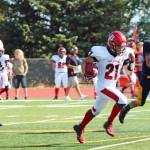 Kenai Central High School senior Zach Burnett breaks away from the Homer defense to make a 62-yard run and touchdown for the Kardinals during a Saturday, Aug. 17, 2019 football game at the Mariner field in Homer, Alaska. (Photo by Megan Pacer/Homer News)