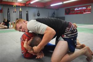 Soldotnas Sean Babitt (on top) grapples with a teammate Thursday at Redemption MMA in Soldotna. Babitt won a division championship at the IBJJF World Championships June 1 in Long Beach, California. (Photo by Joey Klecka/Peninsula Clarion)