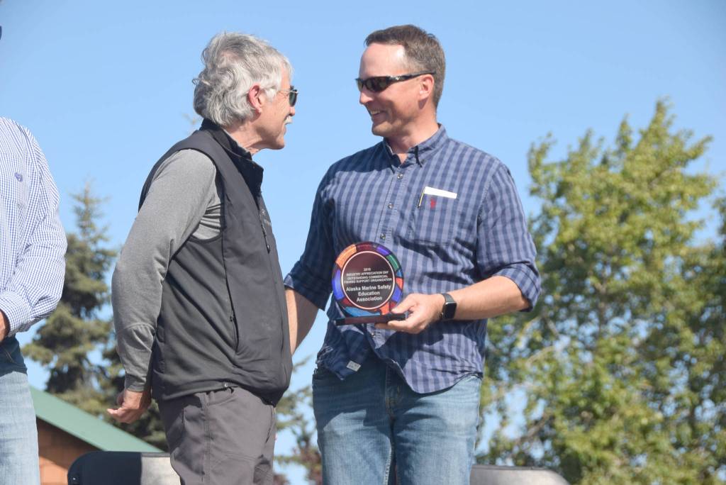 Brian Mazurek / Peninsula Clarion                                Rep. Ben Carpenter (left) , R-Nikiski, presents an award Saturday to Jerry Dzugan, executive director of the Alaska Marine Safety Education Association, for the organizations outstanding support of the commercial fishing industry during Industry Appreciation Day in Kenai.