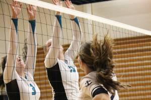 Nikiskis America Jeffreys (left) and Kaycee Bostic put up a block on Homers Laura Inama at the Homer Jamboree against the Homer Mariners on Saturday, Aug. 24, 2019 in the Alice Witt Gymnasium in Homer, Alaska. (Photo by Megan Pacer/Homer News)