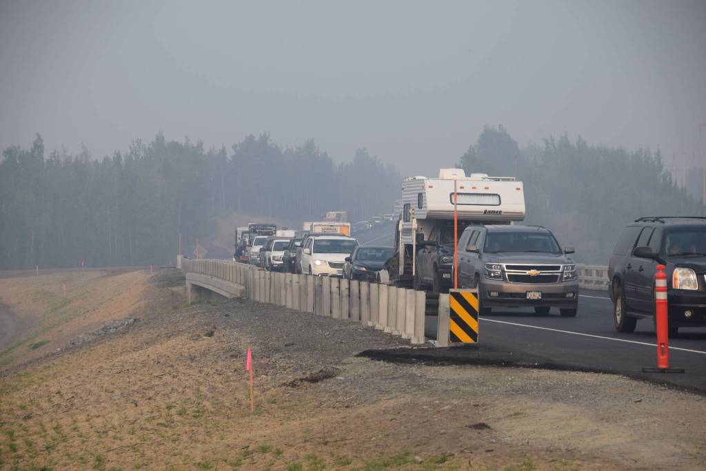 Motorists heading east from Sterling, Alaska wait for a pilot car to escort them down the Sterling Highway on Aug. 30, 2019. (Photo by Brian Mazurek/Peninsula Clarion)