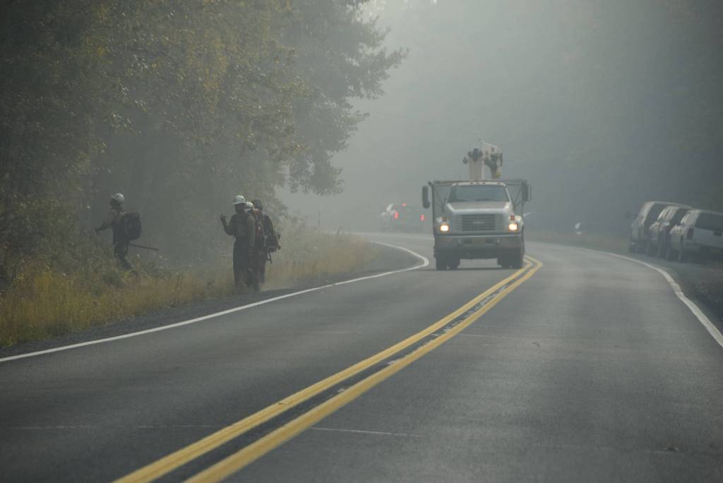 Firefighters can be seen here working along the Sterling Highway near Cooper Landing, Alaska on Aug. 30, 2019. (Photo by Brian Mazurek/Peninsula Clarion)