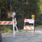 A sign for one of the drop points in Cooper Landing, Alaska can be seen here at the entrance to the Bean Creek Trail on Aug. 30, 2019. Drop points act as meeting points for firefighters working in remote locations and are where supplies such as fuel and spare parts are kept for easy access. (Photo by Brian Mazurek/Peninsula Clarion)