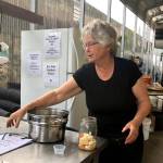 Photo by Victoria Petersen/Peninsula Clarion                                 Bobbi Jackson samples some of her fermented cauliflower and carrots at Jackson Gardens and Nursery, Monday, Aug. 26, near Soldotna.