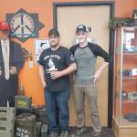 Brian Mazurek / Peninsula Clarion                                Ammo Can Coffee owner Jason Floyd (left) and his son, Liam, are seen here Aug. 16 at their coffee shop in Soldotna.