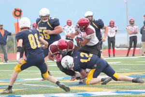 Homer quarterback Anthony Kalugin (12) tackles Houstons Kennedy Fono during a Friday, Sept. 6, 2019 football game between the two teams on the Mariner field in Homer, Alaska. (Photo by Megan Pacer/Homer News)