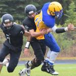 Nikiskis Caileb Payne (left) wraps up Barrow running back Ervin Feleti for a tackle Saturday, Sept. 7, 2019, in Nikiski, Alaska. (Photo by Joey Klecka/Peninsula Clarion)