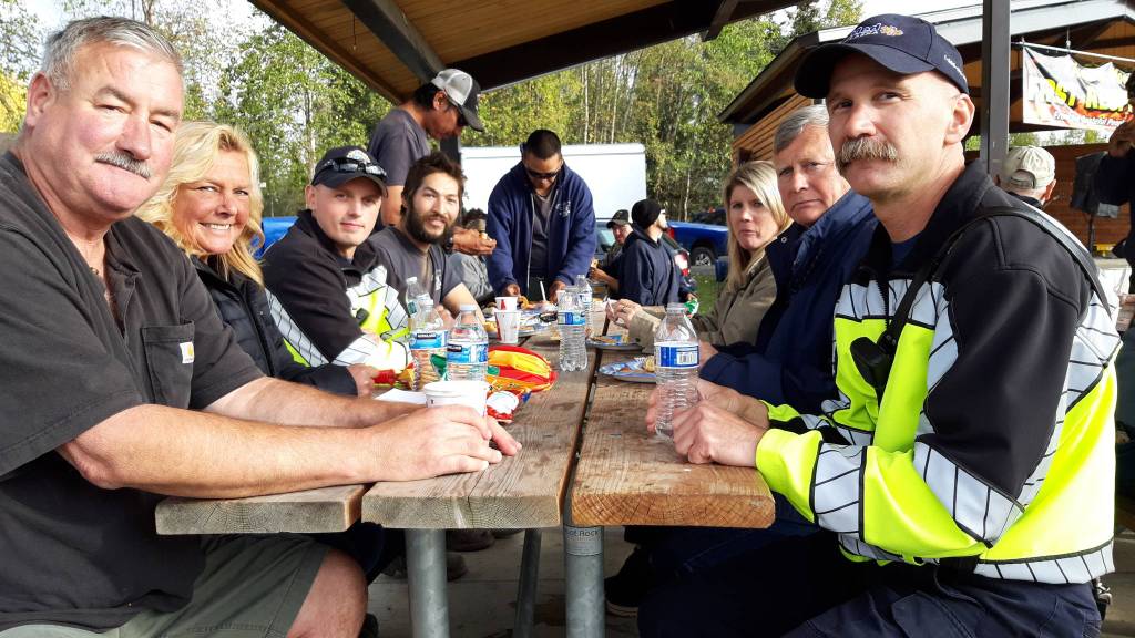 Peninsula residents and firefighters enjoy a meal together during the first responder appreciation barbecue at Soldotna Creek Park on Monday, Sept. 9, 2019, Soldotna, Alaska. (Photo by Brian Mazurek/Peninsula Clarion)