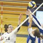 Palmers Kristen Beames (center) and Carli Bowen (right) jump to block a tip from Homers Tonda Smude during a Thursday, Sept. 12, 2019 volleyball game in the Alive Witte Gymnasium in Homer, Alaska. (Photo by Megan Pacer/Homer News)