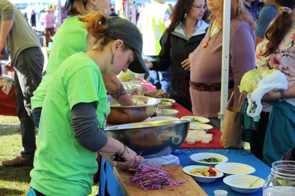 Volunteers work the fermentation station at the Harvest Moon Local Food Festival at Soldotna Creek Park on Sept. 14, 2019. (Photo by Brian Mazurek/Peninsula Clarion)