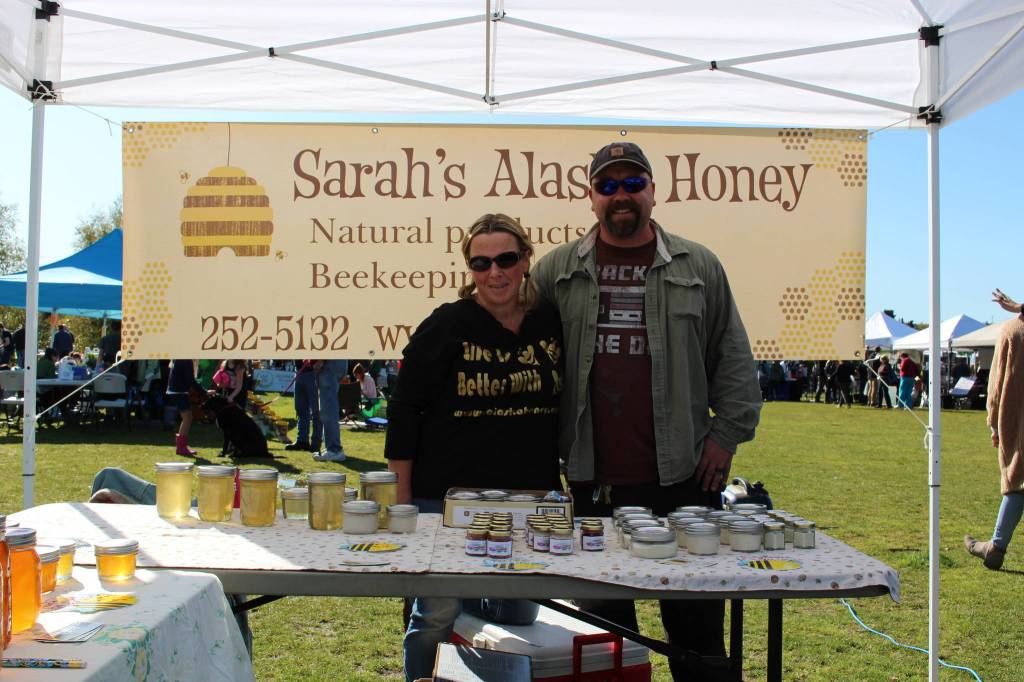 Sarah and Brandon McElrea show off Sarahs Alaska Honey at the Harvest Moon Local Food Festival at Soldotna Creek Park on Sept. 14, 2019. (Photo by Brian Mazurek/Peninsula Clarion)