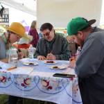 From left, pie contest judges Kelsey Shields, Larry Marsh and Joe Spady deliberate on the best pies at the Harvest Moon Local Food Festival at Soldotna Creek Park on Sept. 14, 2019. (Photo by Brian Mazurek/Peninsula Clarion)