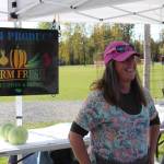 Mary Appelhanz of M&M Produce speaks to customers at the Harvest Moon Local Food Festival at Soldotna Creek Park on Sept. 14, 2019. (Photo by Brian Mazurek/Peninsula Clarion)