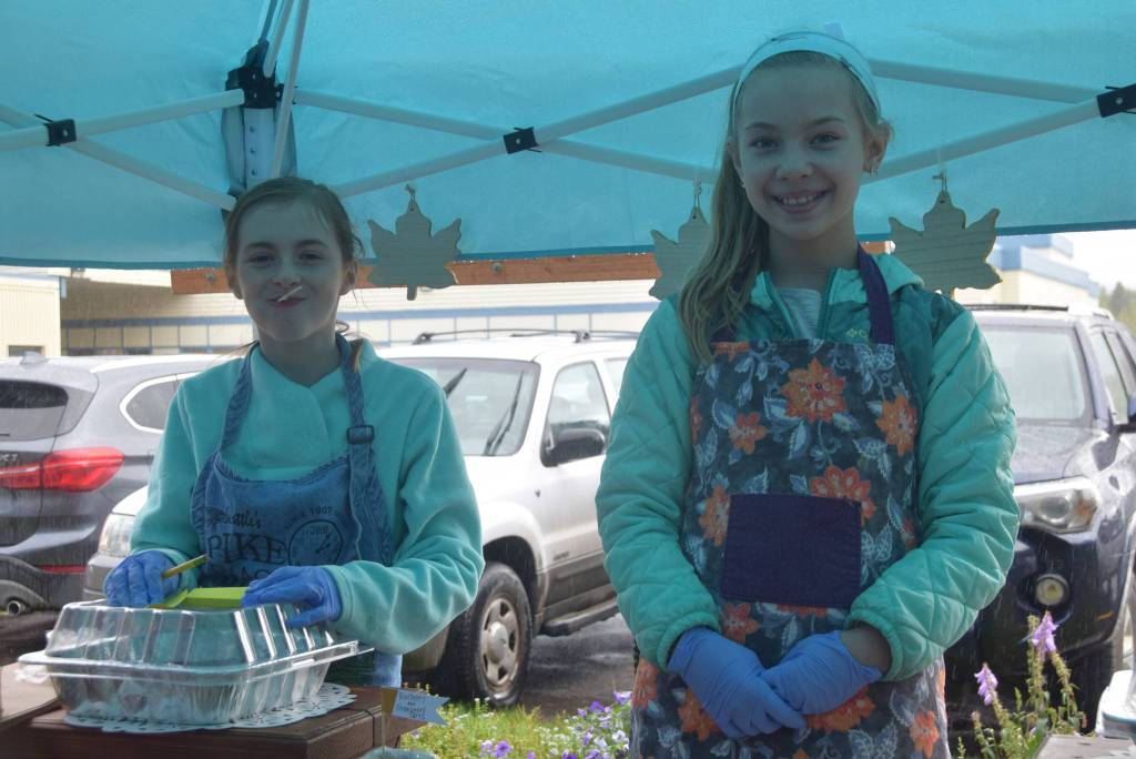 Zoey Vonheeder, left, and Kaitlyn Miller, right, hold down the fort at the baked goods stand during the Montessori Farmers Market at the Soldotna Montessori School on Sept. 13, 2019. (Photo by Brian Mazurek/Peninsula Clarion)