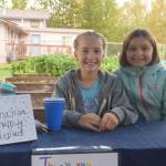 Katie Debardelaben, left, and Aurora Oostman, right, hold down the cash register at the Montessori Farmers Market at the Soldotna Montessori School on Sept. 13, 2019. (Photo by Brian Mazurek/Peninsula Clarion)