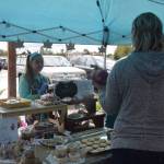 Kaitlyn Miller makes a sale at the baked goods station during the Montessori Farmers Market at the Soldotna Montessori School on Sept. 13, 2019. (Photo by Brian Mazurek/Peninsula Clarion)