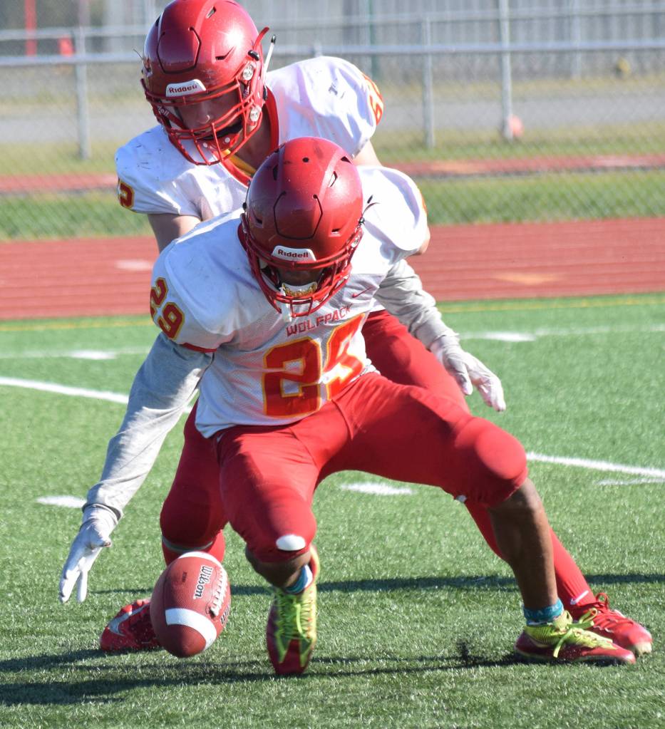 West Valleys Justin Cummings (center) and Malachi Brooks scramble for a Kenai Central fumble Saturday, Sept. 14, 2019, at Ed Hollier Field in Kenai, Alaska. (Photo by Joey Klecka/Peninsula Clarion)