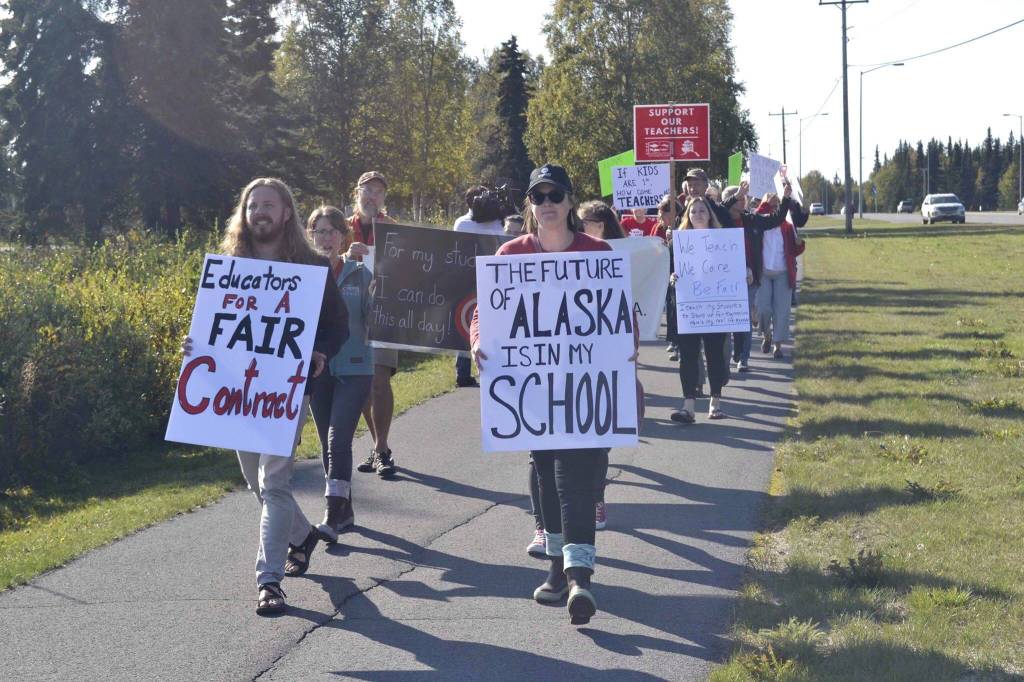 One day before a planned educator strike, teachers and staff rally in front of Kenai Central High School, on Monday, Sept. 16, 2019, in Kenai, Alaska. (Photo by Victoria Petersen/Peninsula Clarion)