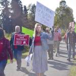Educators rally ahead of a 7 a.m. Tuesday strike deadline on Monday in front of Kenai Central High School. The two teachers associations and the school district reached an agreement Tuesday morning  just hours before the strike deadline. (Photo by Victoria Petersen/Peninsula Clarion)