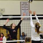 Kenai Central hitter Abby Every (left) pokes a ball over Nikiskis Kaycee Bostic, Tuesday, Sept. 17, 2019, at Nikiski High School. (Photo by Joey Klecka/Peninsula Clarion)