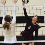 Kenai Central hitter Savanna Wilson (3) sends a shot over Nikiskis Jaycee Tauriainen, Tuesday, Sept. 17, 2019, at Nikiski High School. (Photo by Joey Klecka/Peninsula Clarion)