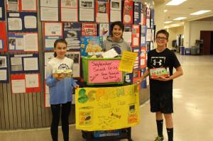 From left, eighth grader Avery Ciufo, student council adviser Sheilah Margaret Pothast and eighth grader Derrick Jones show off the food theyve collected during their snack drive at Skyview Middle School in Soldotna, Alaska on Sept. 20, 2019. (Photo by Brian Mazurek/Peninsula Clarion)