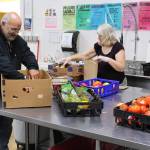 Food Bank volunteers Arnie Sullenger, left, and Mary Sullenger, right, sort produce at the Kenai Peninsula Food Bank in Soldotna, Alaska on Sept. 20, 2019. (Photo by Brian Mazurek/Peninsula Clarion)
