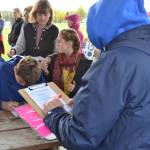 Climate Strike participants sign a petition asking the Kenai Peninsula Borough to incorporate climate change into the boroughs comprehensive plan during Soldotnas Climate Strike on Sept. 20, 2019. (Photo by Brian Mazurek/Peninsula Clarion)