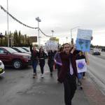 Youth organizer Kaegan Koski leads the participants of the Soldotna Climate Strike down the Sterling Highway in Soldotna, Alaska on Sept. 20, 2019. (Photo by Brian Mazurek/Peninsula Clarion)