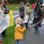 A young participant in the Soldotna Climate Strike smiles for the camera at the intersection of the Sterling Highway and the Kenai Spur Highway in Soldotna, Alaska on Sept. 20, 2019. (Photo by Brian Mazurek/Peninsula Clarion)