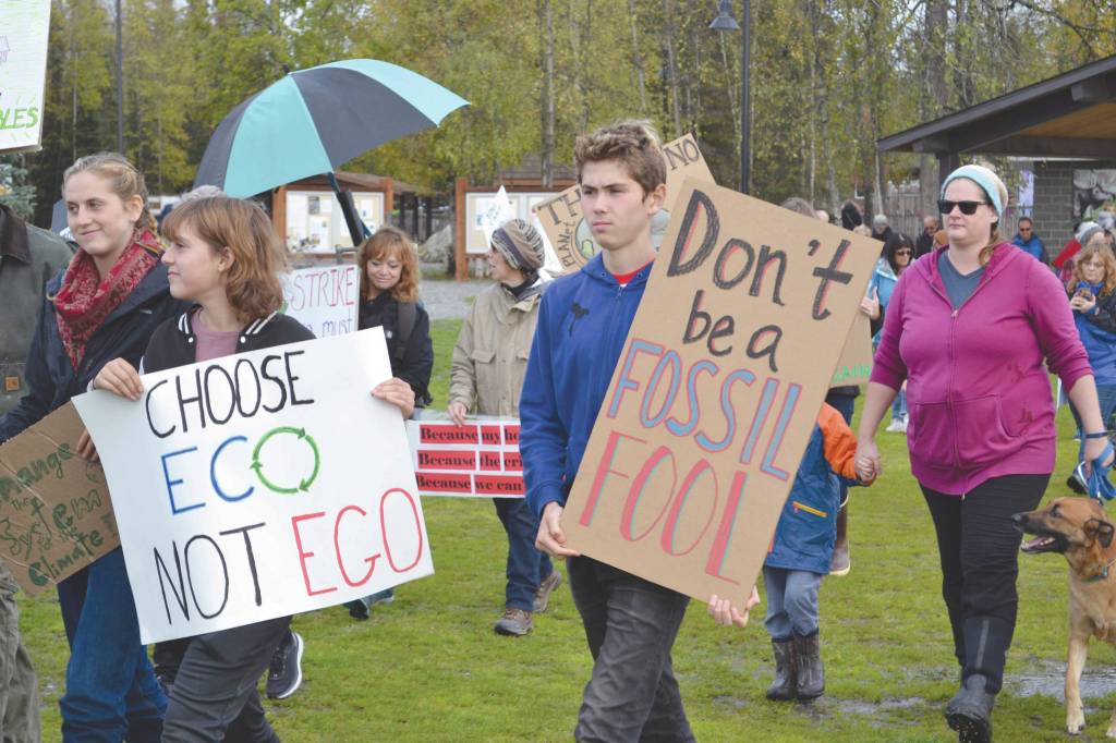 Brian Mazurek / Peninsula Clarion                                Marchers in the Soldotna Climate Strike walk through Soldotna Creek Park toward the Sterling Highway on Friday.