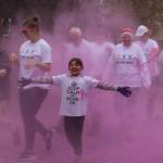 Participants in the 2019 Stomp Out Stigma Color Run make their way through a haze of pink chalk at Soldotna Creek Park on Saturday, Sept. 28, 2019. (Photo by Brian Mazurek/Peninsula Clarion)