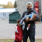 From left, Manny Peterson, Jacob Peterson and baby Ezra Peterson smile for the camera during the Central Emergency Services Open House at Fire Station 1 in Soldotna, Alaska on Sept. 28, 2019. (Photo by Brian Mazurek/Peninsula Clarion)