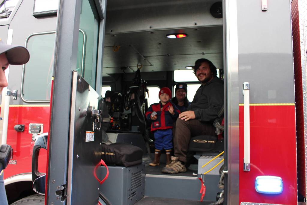 Dakota Hendrickson, Jennifer Hendrickson and Erik Hendrickson check out one of the fire engines during the Central Emergency Services Open House at Fire Station 1 in Soldotna, Alaska on Sept. 28, 2019. (Photo by Brian Mazurek/Peninsula Clarion)