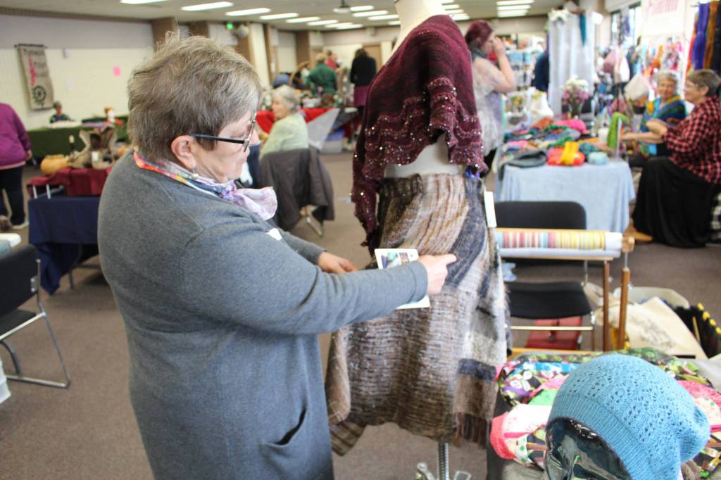 Sharon Koecher shows off a skirt made by her daughter Farrah Weinert during the Fireweed FiberFest at the Soldotna Regional Sports Complex on Sept. 28, 2019. (Photo by Brian Mazurek/Peninsula Clarion)