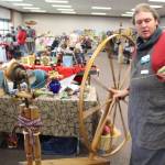 Brian Mazurek / Peninsula Clarion                                Cole Harmon shows off his great wheel  also known as a muckle wheel  during the Fireweed FiberFest at the Soldotna Regional Sports Complex on Saturday, Sept. 28, 2019. Harmon spins with qiviut, which is the inner wool of the musk ox and is harvested by Alaska Native elders in Nome. Harmon discovered recently that his wheel was built in the 1750s out of salvaged shipwreck wood by Quakers on the east coast. The wood itself is about 900 years old and was originally harvested in Scotland.