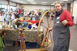 Brian Mazurek / Peninsula Clarion                                Cole Harmon shows off his great wheel  also known as a muckle wheel  during the Fireweed FiberFest at the Soldotna Regional Sports Complex on Saturday, Sept. 28, 2019. Harmon spins with qiviut, which is the inner wool of the musk ox and is harvested by Alaska Native elders in Nome. Harmon discovered recently that his wheel was built in the 1750s out of salvaged shipwreck wood by Quakers on the east coast. The wood itself is about 900 years old and was originally harvested in Scotland.