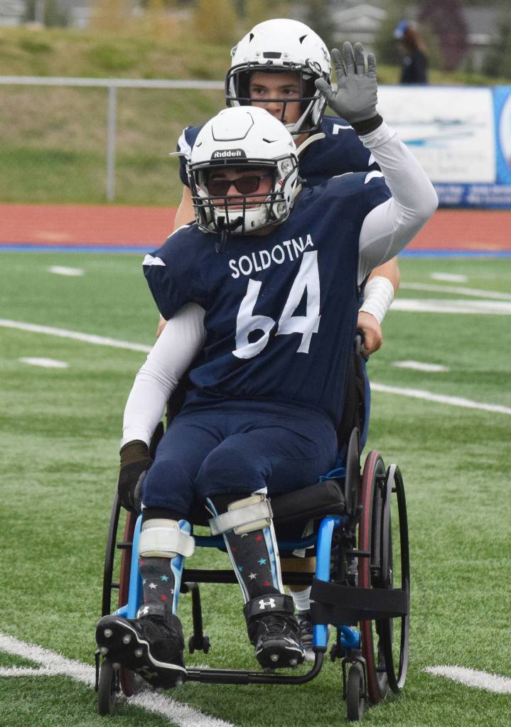 Soldotna senior manager Matthew Martinelli is pushed off the field after taking the first snap of Saturdays game against Eagle River at Justin Maile Field in Soldotna. (Photo by Joey Klecka/Peninsula Clarion)